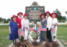 Blue Star ladies standing in front of the Blue Star Memorial